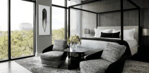 Instagram - Four Poster Bed withTwo Lounge Chairs and A Side Table With Flowers In A Glass Vase and Art On The Wall - G Residence 1 - Nina Magon.jpg